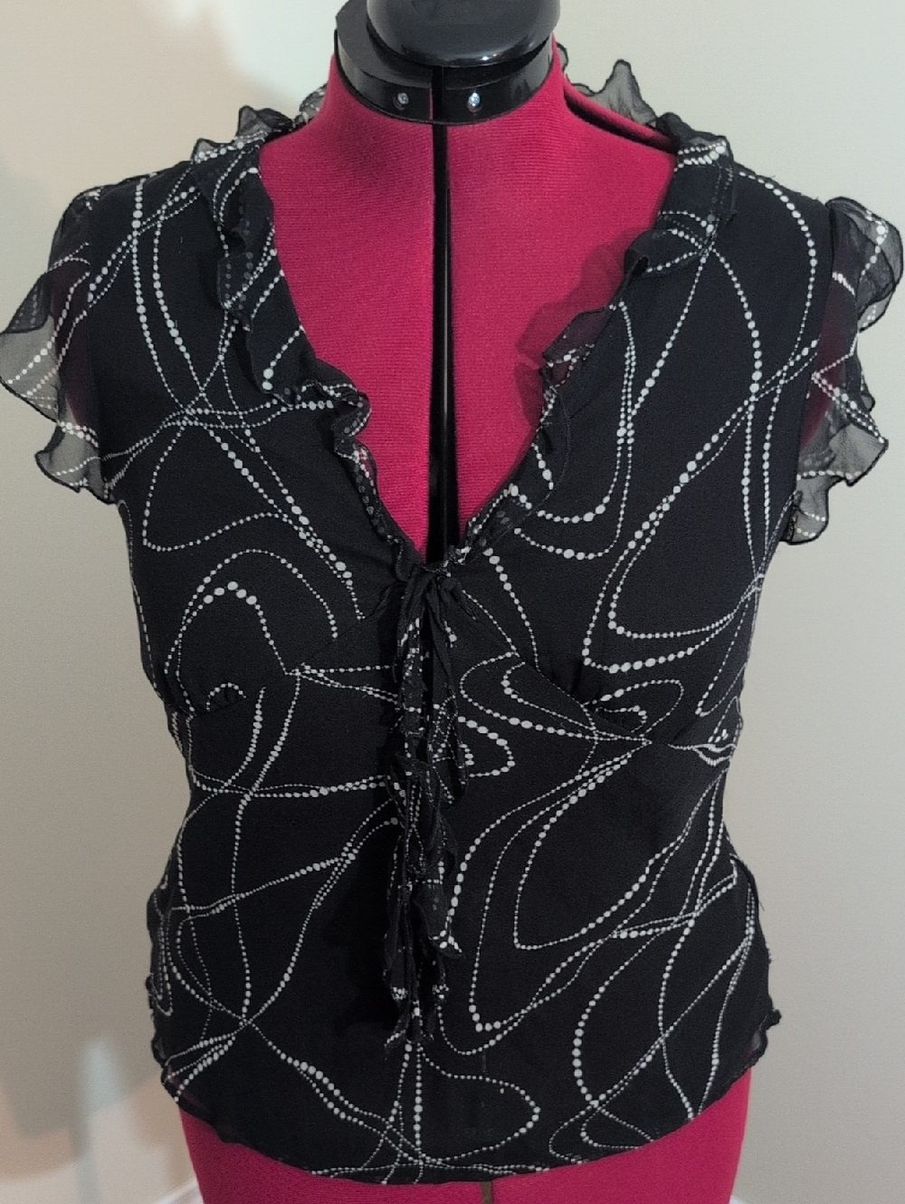 Allison Taylor | Black Ruffle Tie-Front Women's Top with White Dot Swirl Pattern